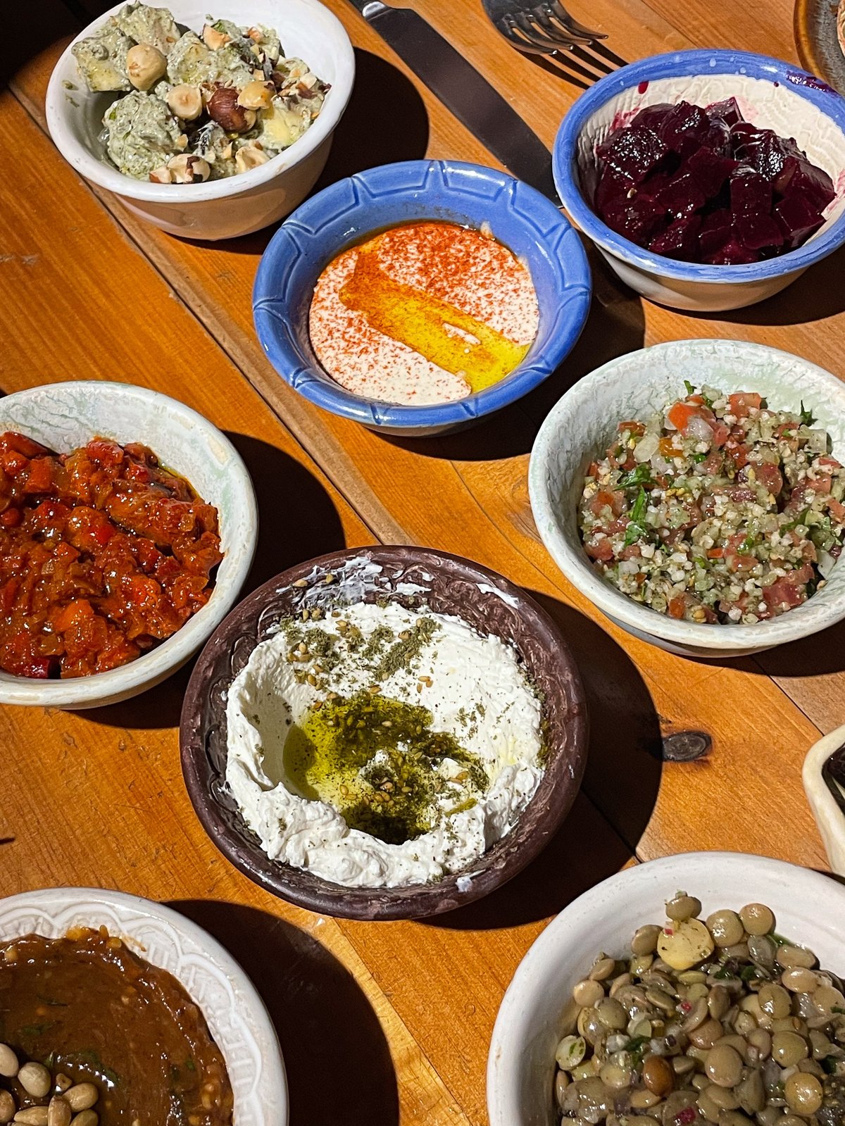 Mezze platter featuring many small plates of Mediterranean food