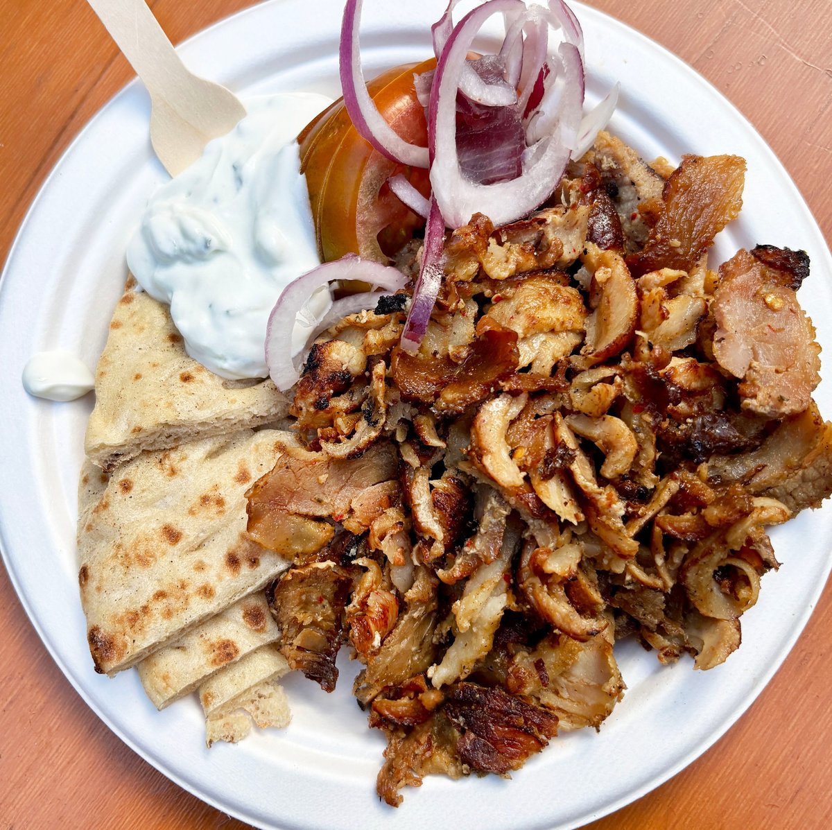 Authentic Greek food platter with souvlaki skewers, gyros meat, pita bread and tzatziki